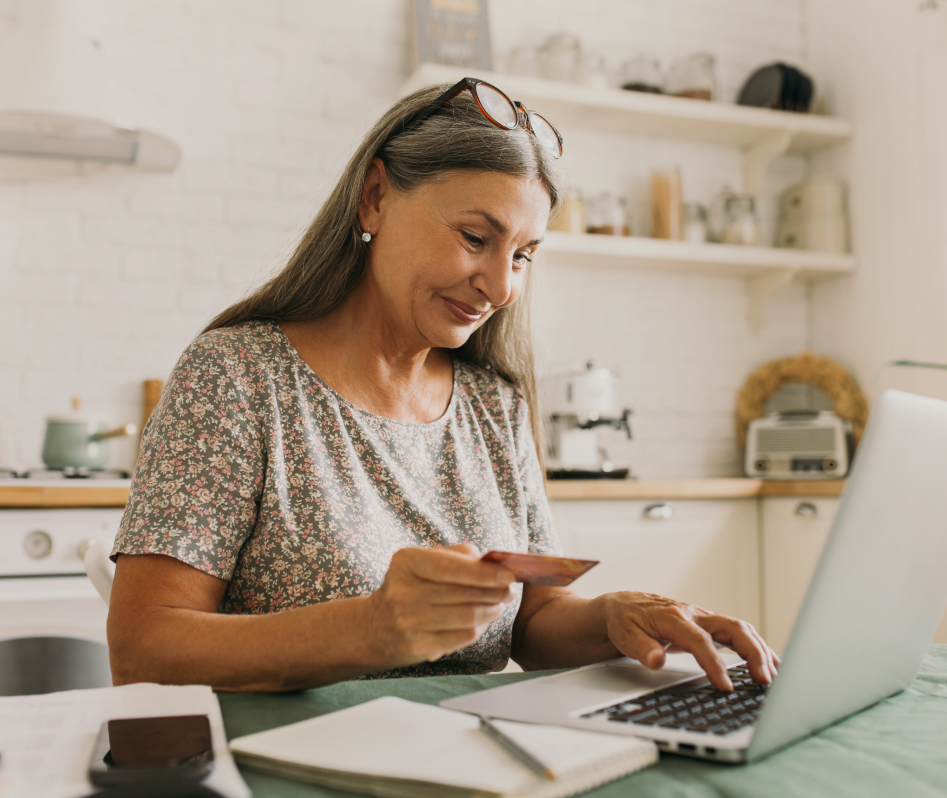 Older woman on a laptop making an online purchase